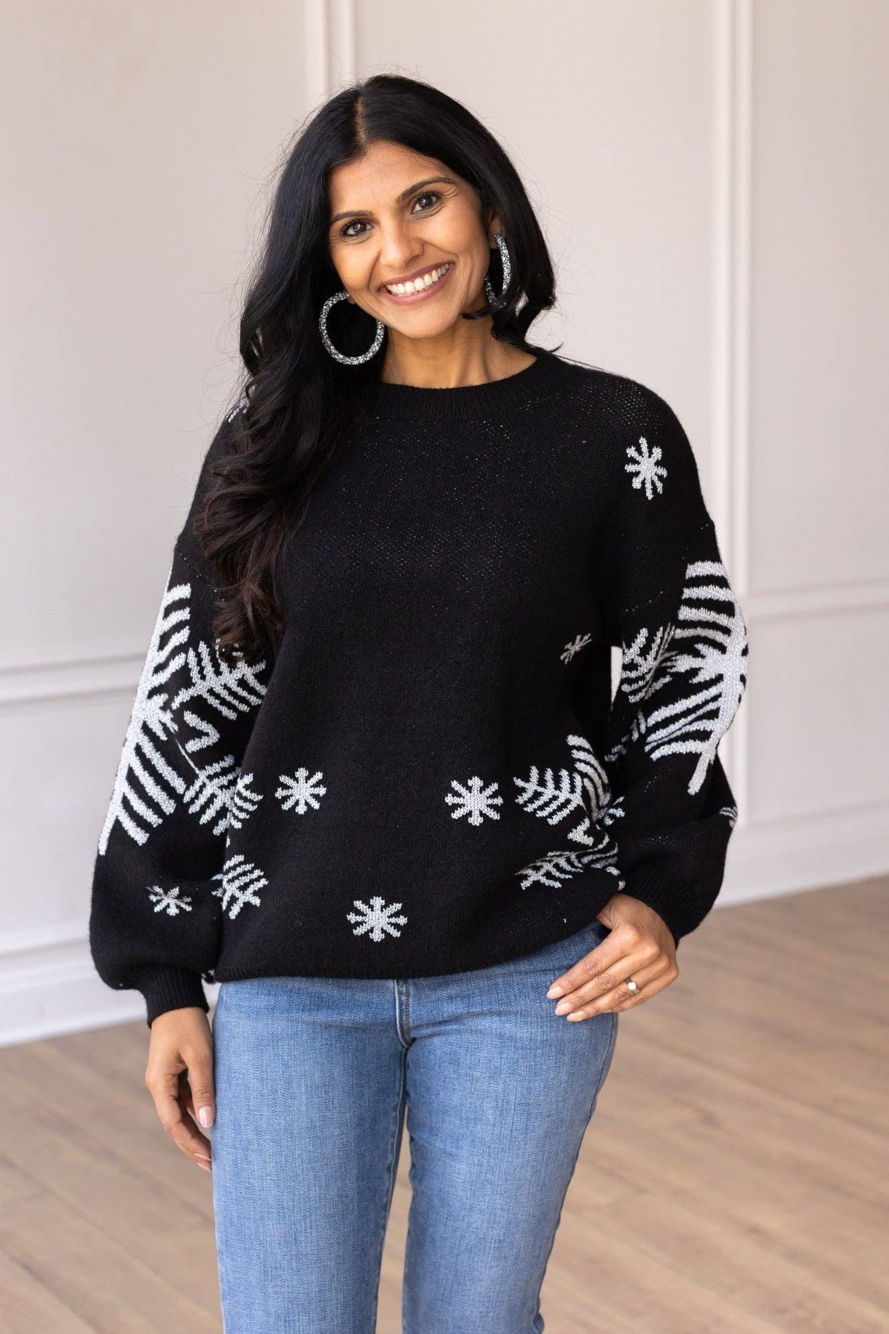 65% cotton / 35% polyester
The Nightfall Frost Black Sweater with Silver Snowflakes is designed for both fashion and warmth. The relaxed fit ensures ease of movement, while the soft fabric provides a cozy and delightful feel against your skin. Pair it with a skirt and heels for a chic and elegant look, or wear it with jeans and ankle boots for a trendy and festive ensemble.
Fit: Relaxed, model is wearing a small.