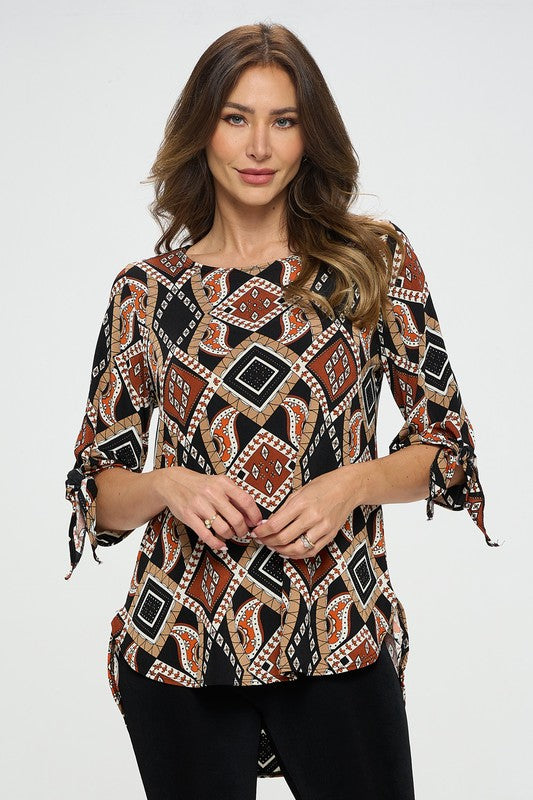 90% polyester / 10% spandex The best part of dressing up is when it can be in a soft flowing top! This gorgeous earth toned top features a modest round neck and a tied off bell sleeve at the elbow making it a perfect choice as business casual or casual dress up! Made in USA