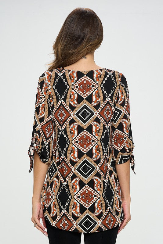 90% polyester / 10% spandex The best part of dressing up is when it can be in a soft flowing top! This gorgeous earth toned top features a modest round neck and a tied off bell sleeve at the elbow making it a perfect choice as business casual or casual dress up! Made in USA