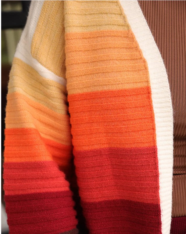Close-up of a striped fabric with orange, red, and beige colors.