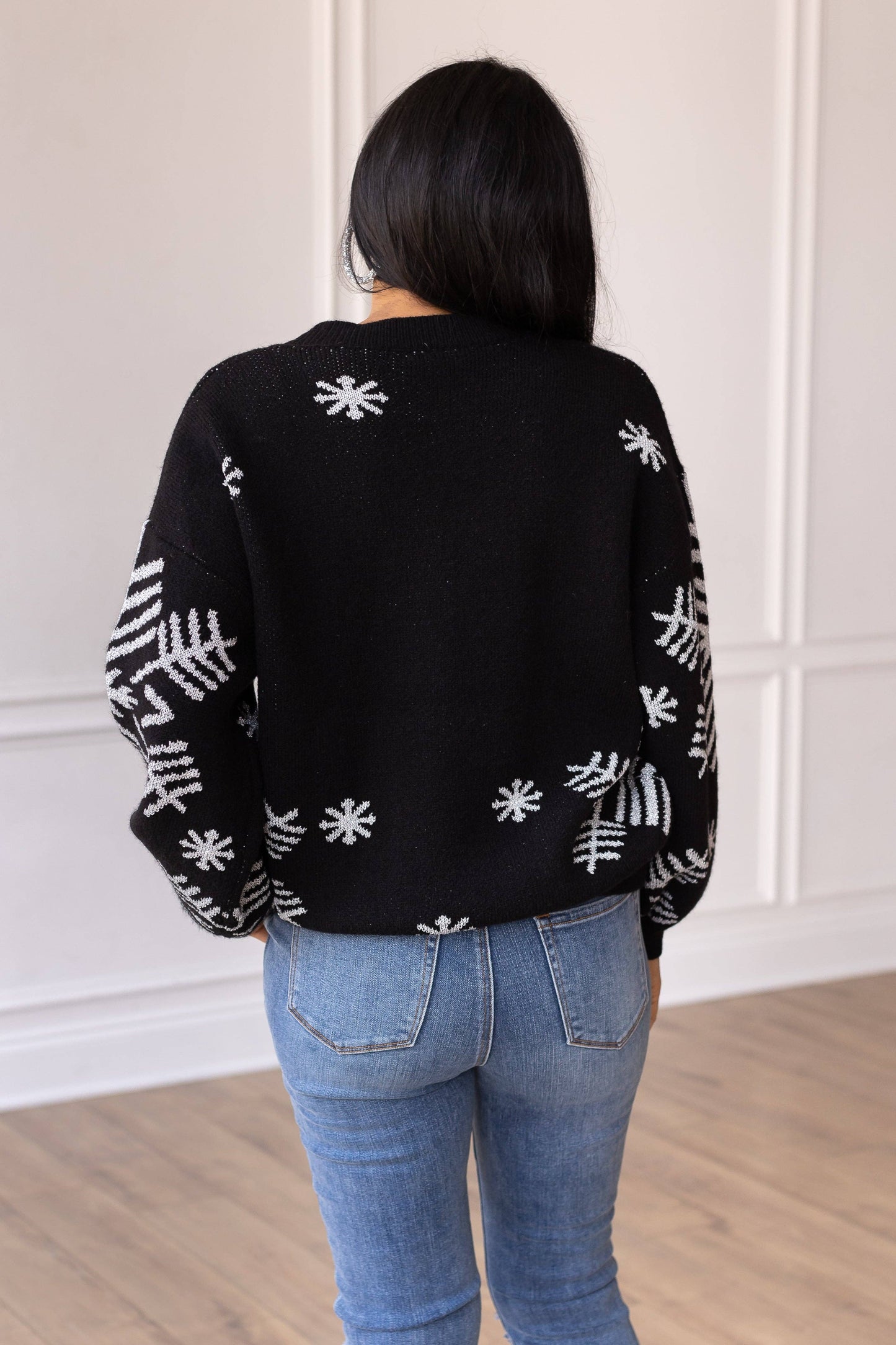 65% cotton / 35% polyester
The Nightfall Frost Black Sweater with Silver Snowflakes is designed for both fashion and warmth. The relaxed fit ensures ease of movement, while the soft fabric provides a cozy and delightful feel against your skin. Pair it with a skirt and heels for a chic and elegant look, or wear it with jeans and ankle boots for a trendy and festive ensemble.
Fit: Relaxed, model is wearing a small.