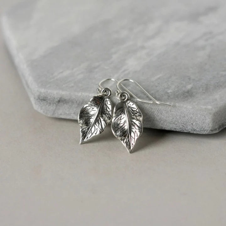 High Quality Stainless Steel A simple silver leaf dangles on each ear, the charms are slightly over a half inch- dainty and shiny- super cute!
