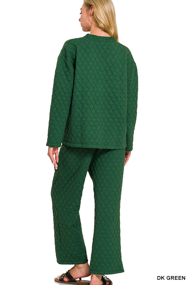 Person wearing a green quilted outfit on a white background
