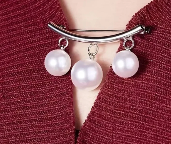 A beautiful triple pearl drop blouse or cardigan closure pin. It's both chic and playful, functional and decorative! Use it to seal up any wardrobe gaps or add some glamour to your ensemble!