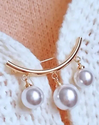 A beautiful triple pearl drop blouse or cardigan closure pin. It's both chic and playful, functional and decorative! Use it to seal up any wardrobe gaps or add some glamour to your ensemble!