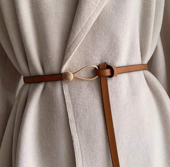 A funky faux leather wrap belt that's adjustable by personal style fit! Measuring 3/8" in width and a flat 46.5" length.
