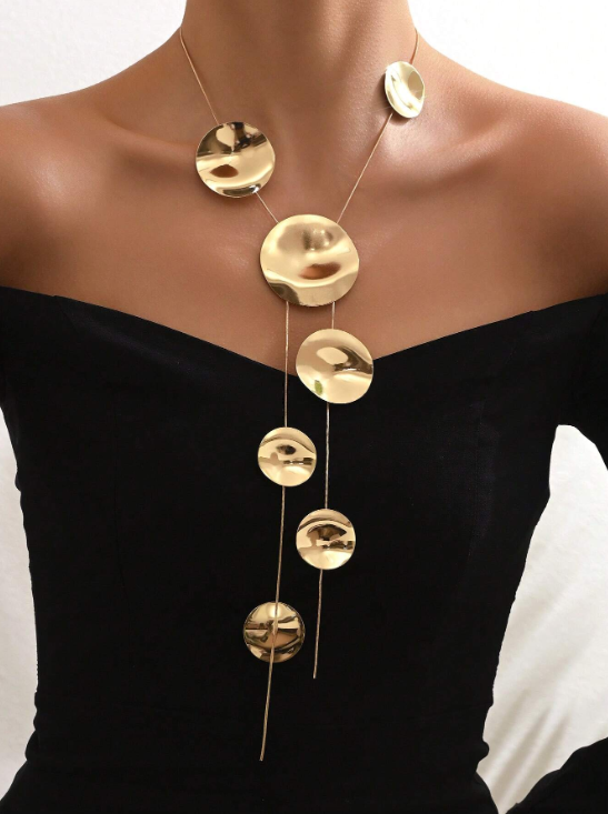 This necklace is a showpiece guaranteed to get you noticed! This geometric hammered look circles form a perfect frame before falling into two separate chains. 