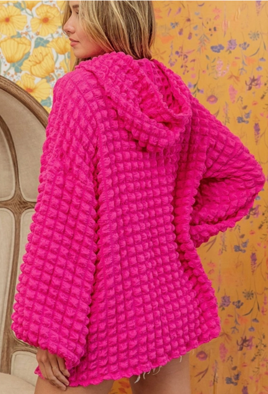 95% polyester / 5% elastane This bubbly textured material gives off a fun and carefree vibe, making it a must-have for any wardrobe. Its relaxed hoodie design is perfect for all body types and looks great with jeans or skirts!
