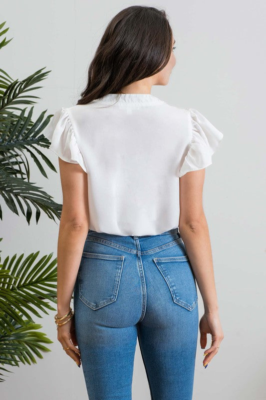 <p>100% polyester</p> <p>You'll be singing with the angels in this cute top! This mock neckline has a v-cut in the front and is embellished with dainty floral lace pattern detail and short flutter sleeves.</p>