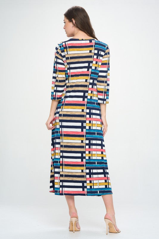 94% polyester / 6% spandex  Elevate your wardrobe with this stunning V-Neck Long Dress With Pocket. Crafted from premium lightweight fabric, this dress is designed to flatter without sacrificing comfort. Featuring pockets for convenience, no-wrinkle construction, and a midi length decorated with a colorful geometric print, this dress exudes effortless sophistication.  Hand or machine wash in cold water.  Made in U.S.A