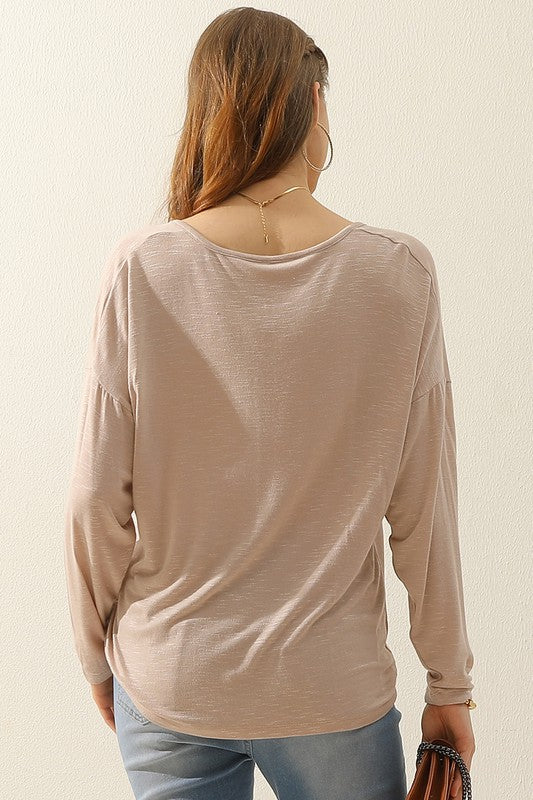 Say hello to your new layering bae--this v-neck top is a total must-have! With a half zip front and a soft textured fabric, it's beyond basic!