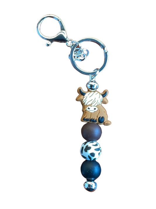 Scottish Highland Cows never fail to delight and this key chain is great way to have them by your side. The beads are brown, spotted cow and black. Est. 5.5" in length (the whole keychain)