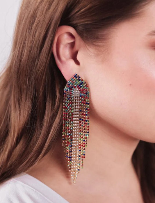 Multicolored beaded earring worn by a person with a neutral background