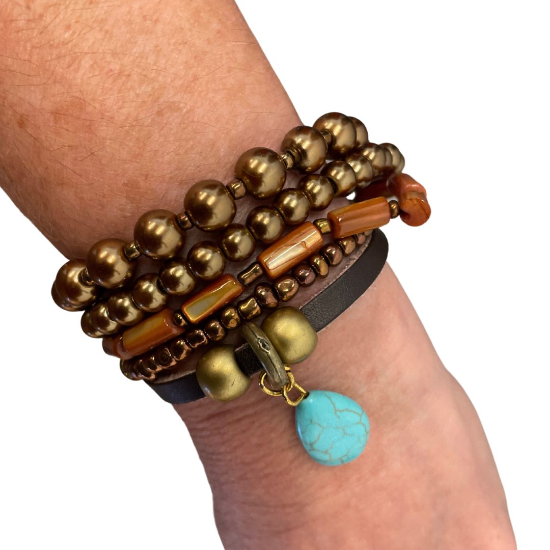 This petite band bracelet attracts interest blending strands of leather, beads & metal finished off with a turquoise teardrop, This is a fun piece to wear!  Measures 7"