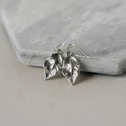 High Quality Stainless Steel  A simple silver leaf dangles on each ear, the charms are slightly over a half inch- dainty and shiny- super cute!