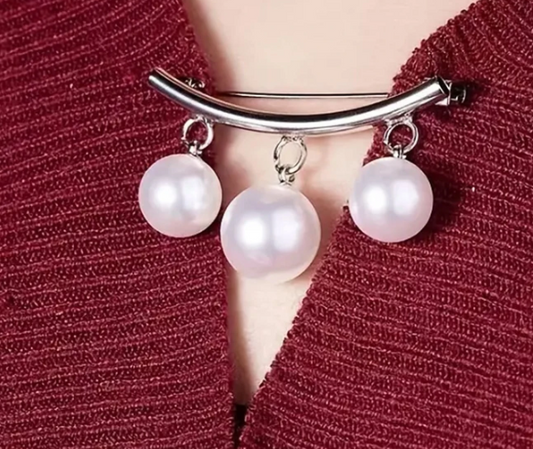 A beautiful triple pearl drop blouse or cardigan closure pin. It's both chic and playful, functional and decorative! Use it to seal up any wardrobe gaps or add some glamour to your ensemble!