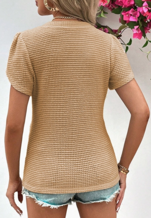 65% polyester / 35% viscose / 5% elastane  &nbsp;Love this flattering v-neck in super soft waffle knit fabric. It's a tee but with the petal sleeves- this is a great piece to dress up or go casual in!