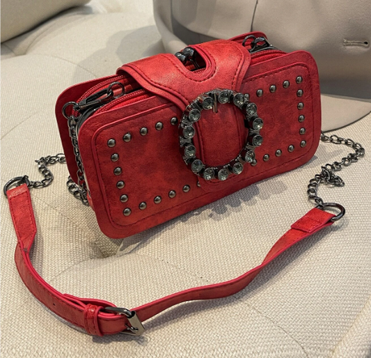 Sassy Satchel? You bet! This petite purse packs a bold punch with the studs and decorative buckle.