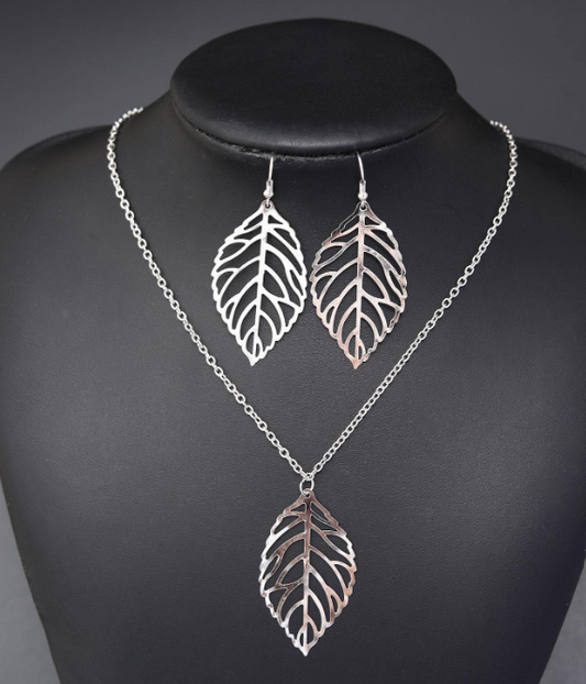 Delight in the charm of these lovely leaf cutout pieces on both the necklace and earrings, adding a bold statement to your ensemble!

Necklace Adjustable 18" to 20"

Earring drop to 2.5", 1.5" wide