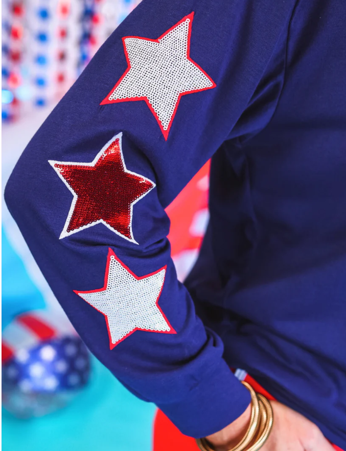 60% polyester / 35% rayon / 5% spandex

Get ready to shine with our USA Sequin Star Top! Featuring eye-catching sequin lettering and star sleeves outline in embroidery, this top is perfect for making a statement. Order yours now and be the star of any event!

Suggested Sizing: Small fits size 2-4; Medium fits size 6-8; Large fits size 10-12; XL fits 14-16; 2XL fits 18