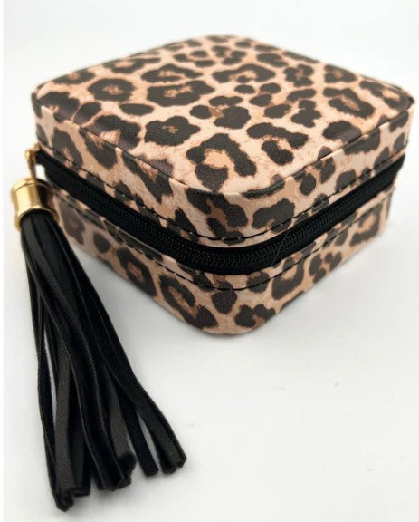 Leopard print jewelry box with a black tassel on a white background
