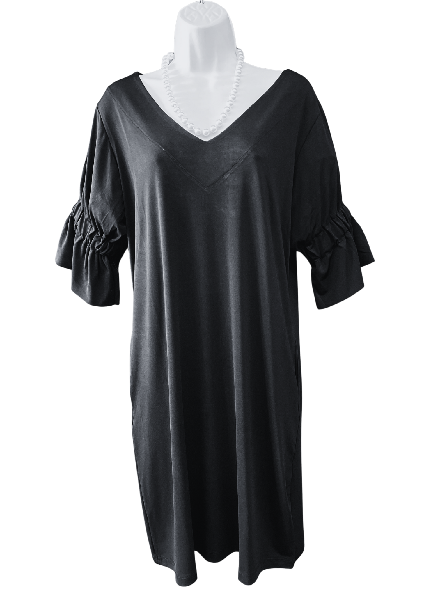 95% polyester 5% Spandex  This dress is a serious improvement on the ol' 'little black dress'--get a load of the sweet gathered sleeve that gives just the right amount of poof! Machine wash warm, gentle cycle. Hang to dry, or tumble dry low.