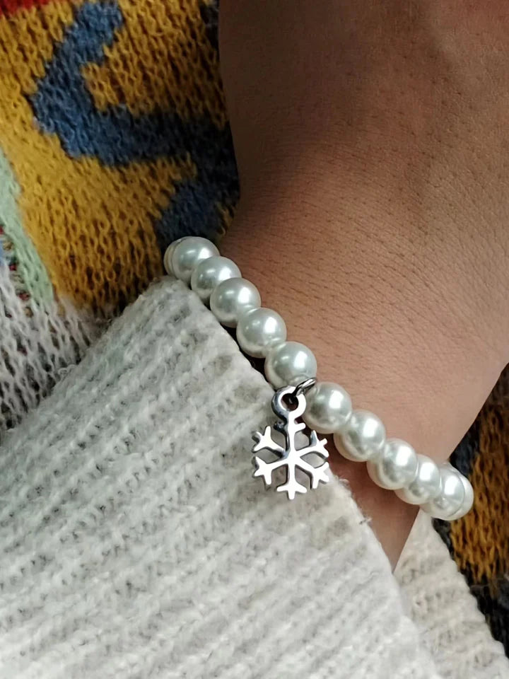 High Quality Stainless Steel  Snow white pearl bracelet with a snowflake charm. The length is adjustable with the lobster claw clasp.