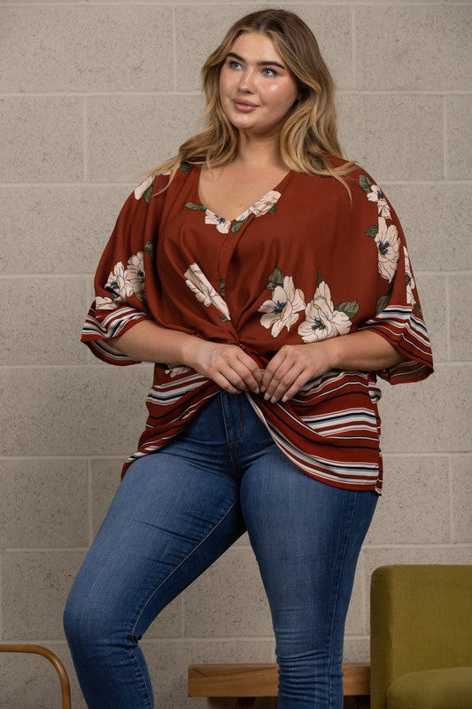 100% polyester  This unique front twist blends a floral into a flattering horizontal stripe on the hips. The fabric gives is a sleek drape and relaxed fall around the waist.   Made in the USA